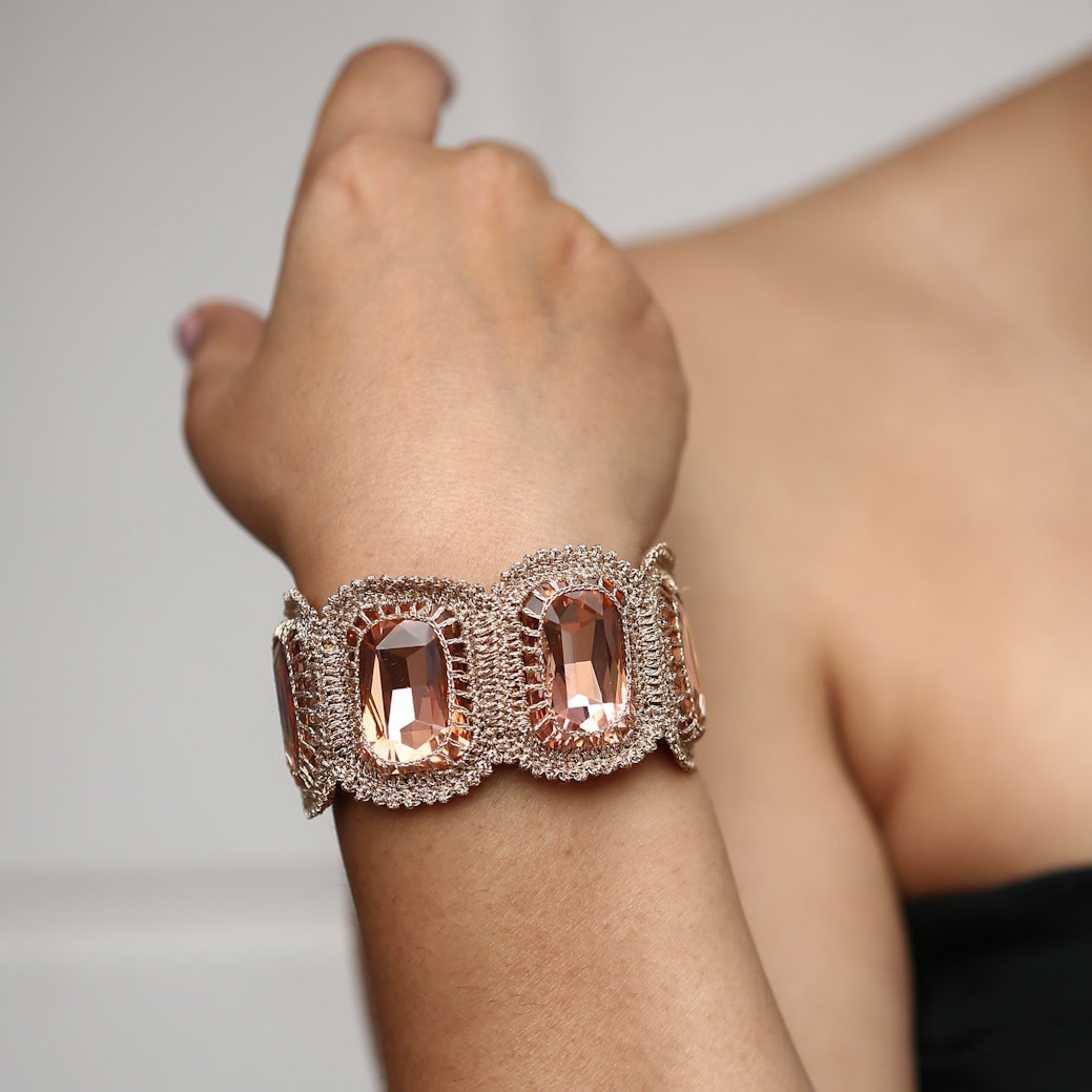 Amelia Crystal Soft Statement Bracelet in Blush colour wrapped around a model's wrist.