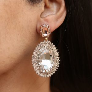 Oval Crystal Drop Statement Earrings with a blush colour earring top and clear crystal drop worn by a model.