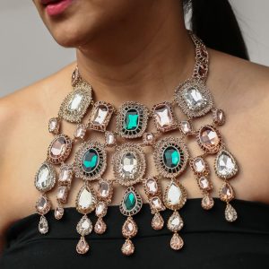 Rosalie Bib Statement Necklace in Blush, Champagne and Emerald colour worn by a model.